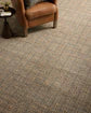 Brown carpet with a subtle pattern on a plain background