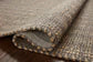 Close-up of textured brown fabric with a subtle pattern