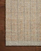 Textured woven rug with a grid pattern on a neutral background